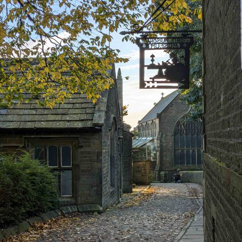 Cobbled street, overhanging trees and the old school room.