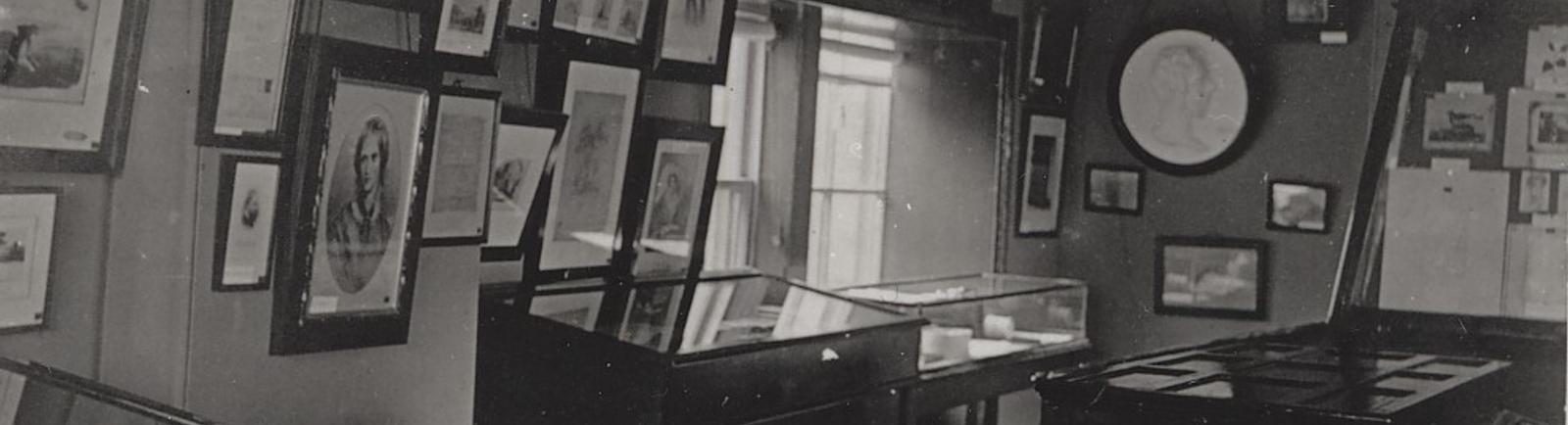 Inside the first Bronte Museum at the Yorkshire Penny Bank. Filled with frames on the walls.