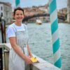 A woman stood by the water in Venice