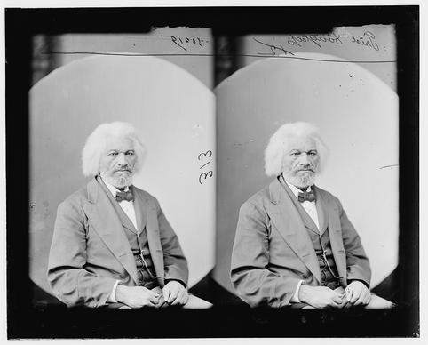 Black and white photograph of an elderly Black man with white hair. Wearing a suit and bow tie.