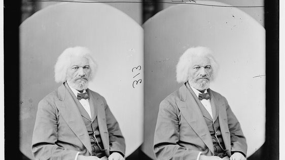 Black and white photograph of an elderly Black man with white hair. Wearing a suit and bow tie.