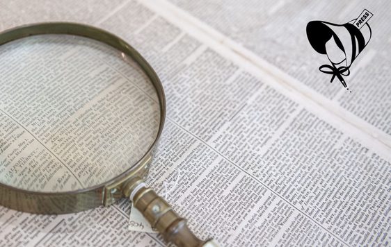 A newspaper and magnifying glass.