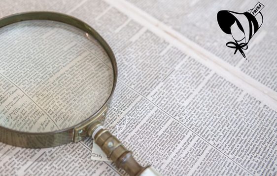 A newspaper and magnifying glass.