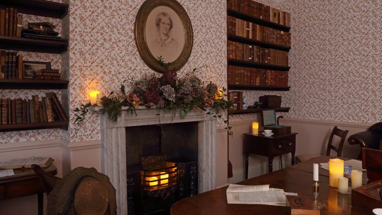 The Dining room lit by candlelight and plants around the fireplace.