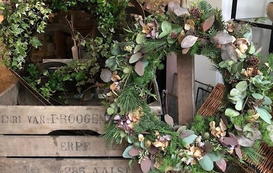 Two wreaths made from greenery.