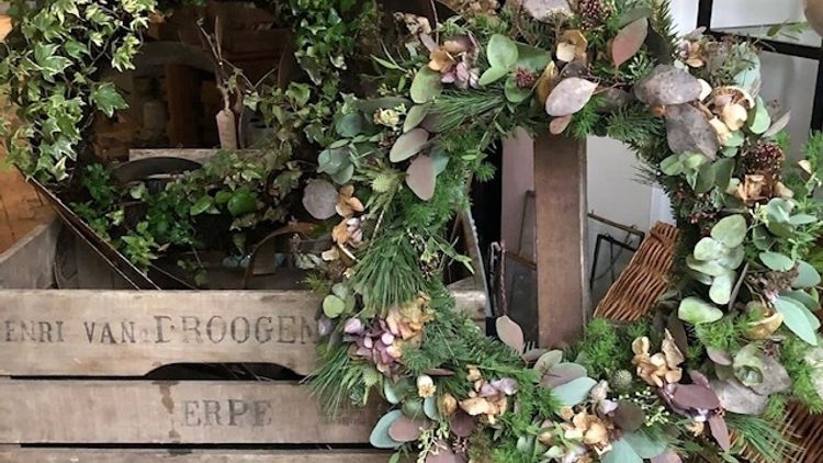 Two wreaths made from greenery.