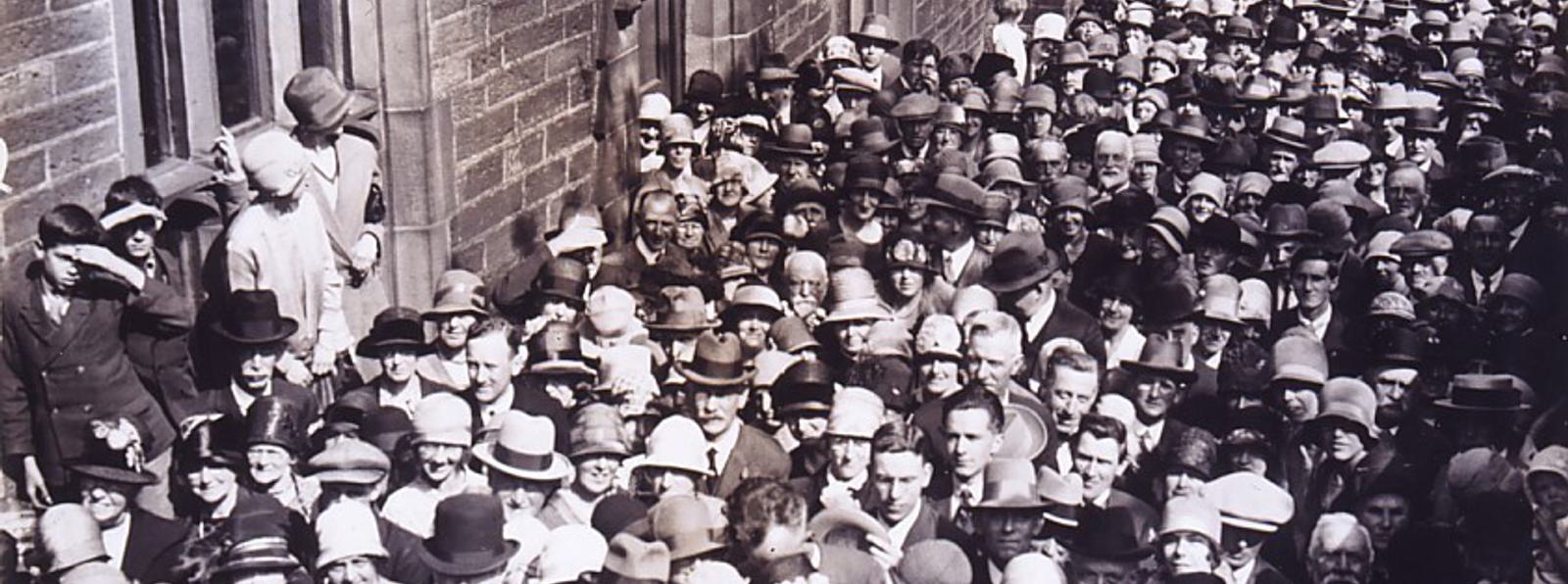 Black and white photo of a crowd of people in the 1920s.