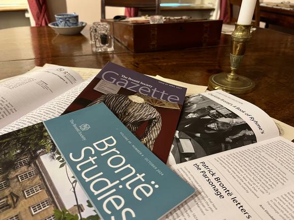 Bronte Studies and the Gazette on the dining table, with Bronte objects.