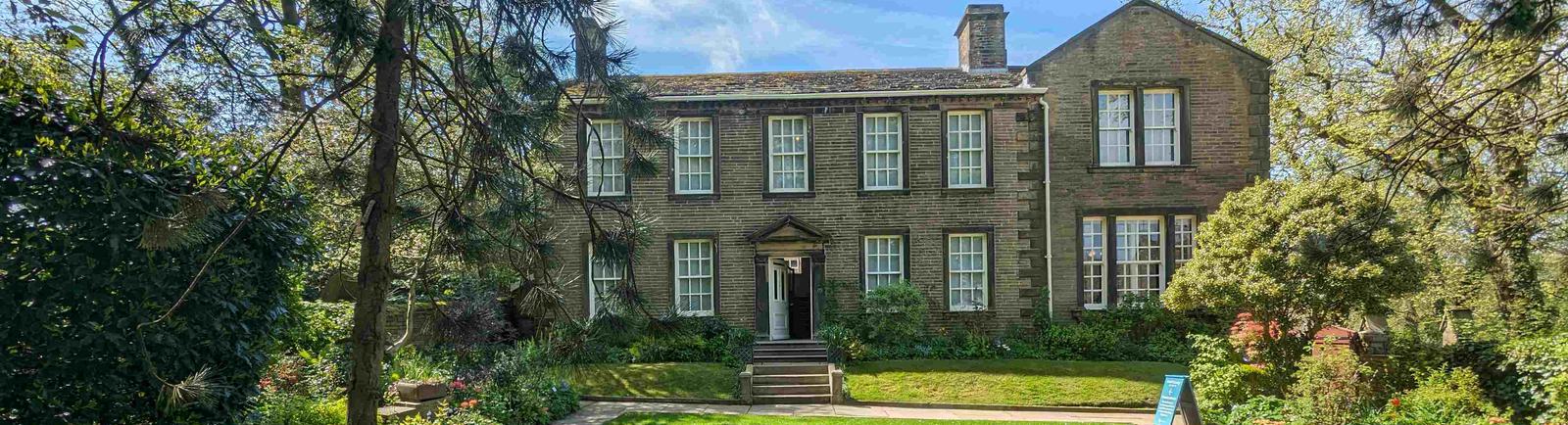 The Bronte Parsonage Museum and garden from the back garden wall. Taken on a sunny summer's day.
