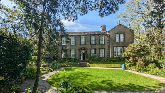 The Bronte Parsonage Museum and garden from the back garden wall. Taken on a sunny summer's day.