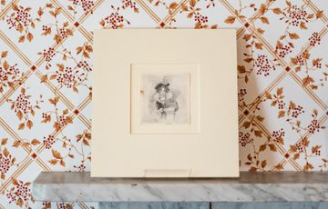 Drawing of a woman with curly hair and fine clothes.