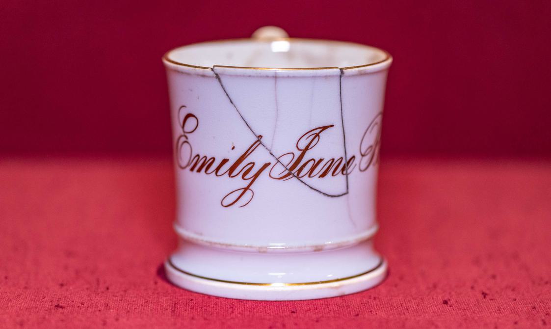 Photo of Emily Brontë's christening mug with her name engraved.