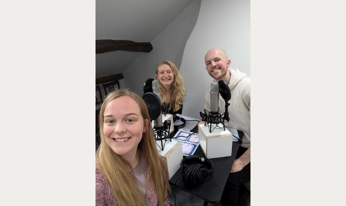 Selfie of three people recording a podcast.