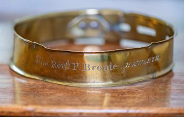 Photo of an inscribed, bronze dog collar.