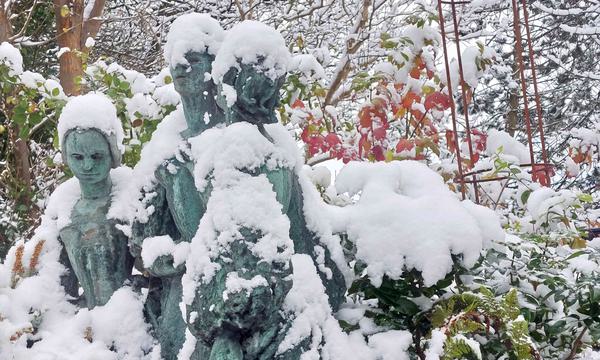 Photo of a snowy statue of three women.