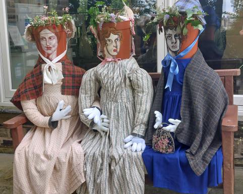 Photo of three flower-pot ladies.