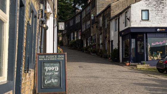 Photo of a cobbled street lined with picturesque buildings.